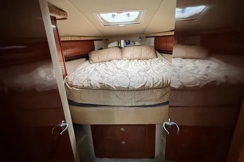 Slide: The Image of Interior cabin of 2005 Sea Ray 420 Sundancer with cozy bed and wooden finish. - 10