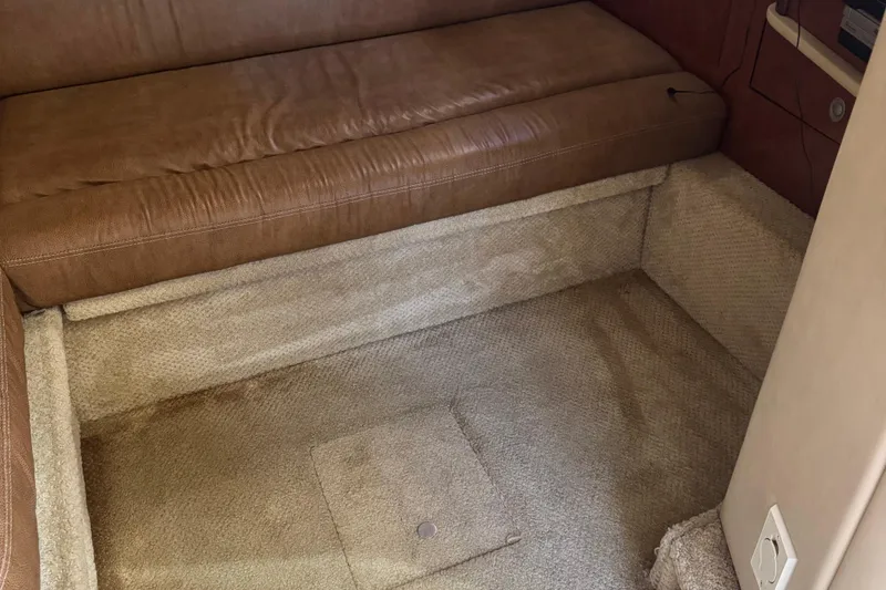 Slide: The Image of Interior of 2005 Sea Ray 420 Sundancer with brown leather seating and beige carpet. - 16