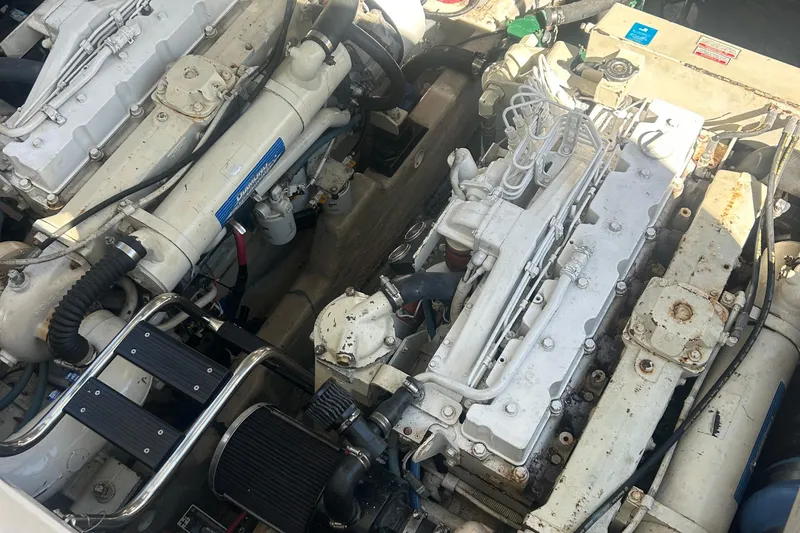 Slide: The Image of Engine compartment of a 2005 Sea Ray 420 Sundancer, showcasing dual inboard engines. - 18