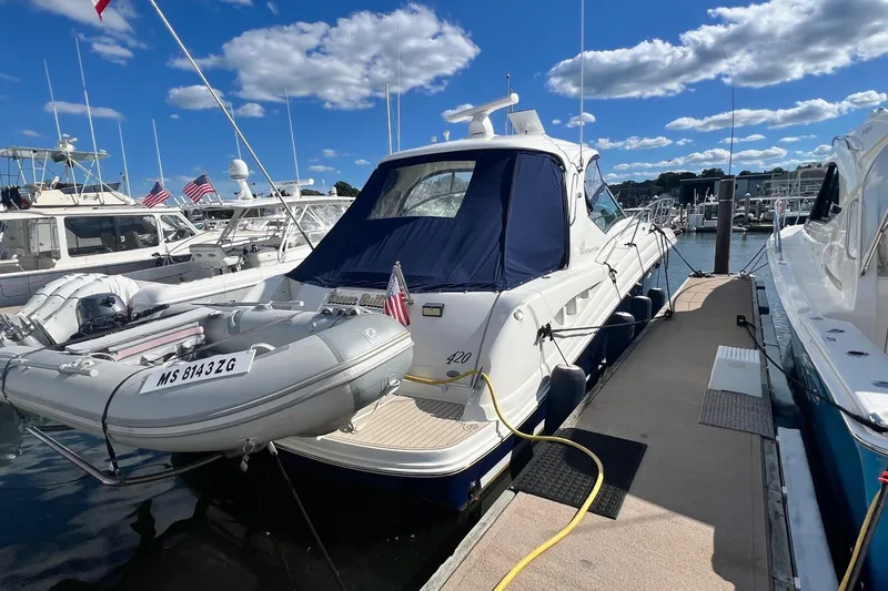 Slide: The Image of 2005 Sea Ray 420 Sundancer yacht docked at marina under blue sky. - 3