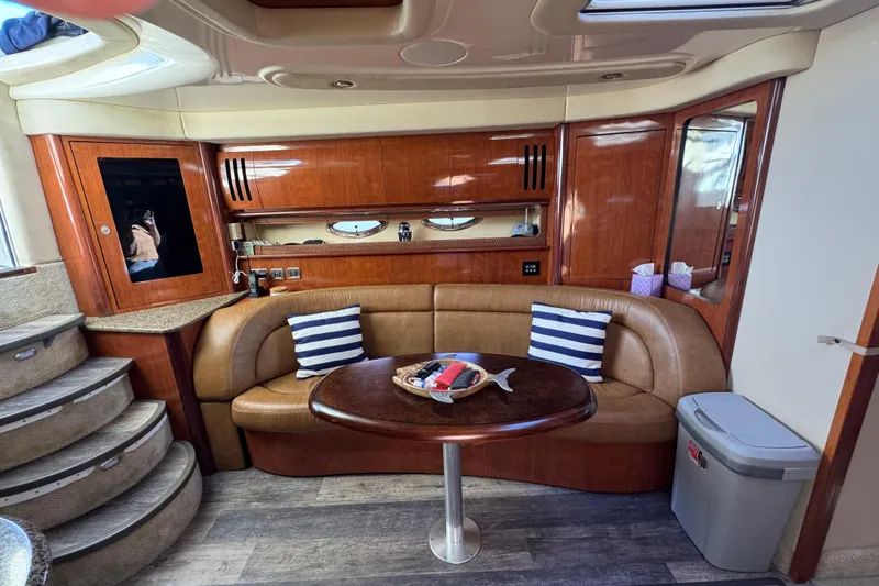 Slide: The Image of Luxurious 2005 Sea Ray 420 Sundancer yacht interior with curved seating and wooden cabinetry. - 6