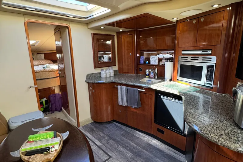 Slide: The Image of Luxurious 2005 Sea Ray 420 Sundancer yacht interior with modern kitchen and cozy bedroom. - 7