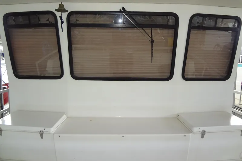 Slide: The Image of Interior of a 2005 Gibson 44 boat with three windows and a bench seat. - 10