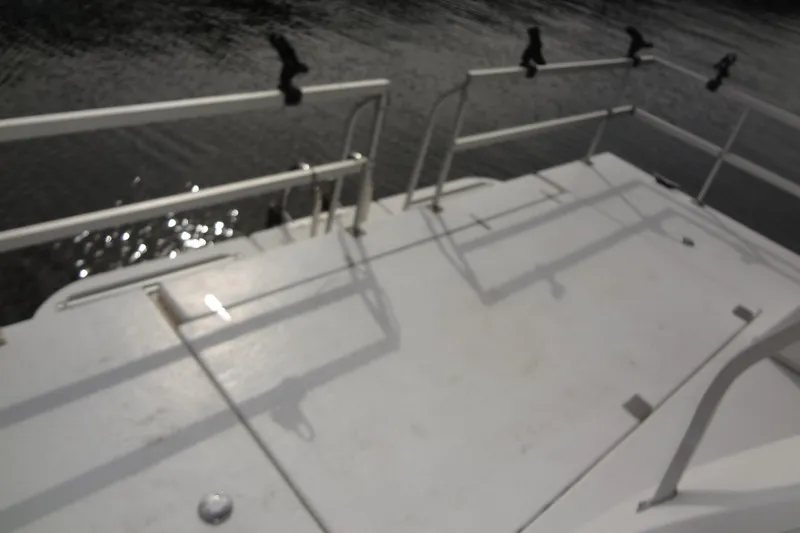 Slide: The Image of Rear deck of a 2005 Gibson 44 boat with railing and water view. - 11