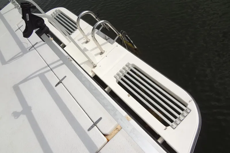 Slide: The Image of Boat deck with ladder and railing, Gibson 44 model, 2005, near water. - 13
