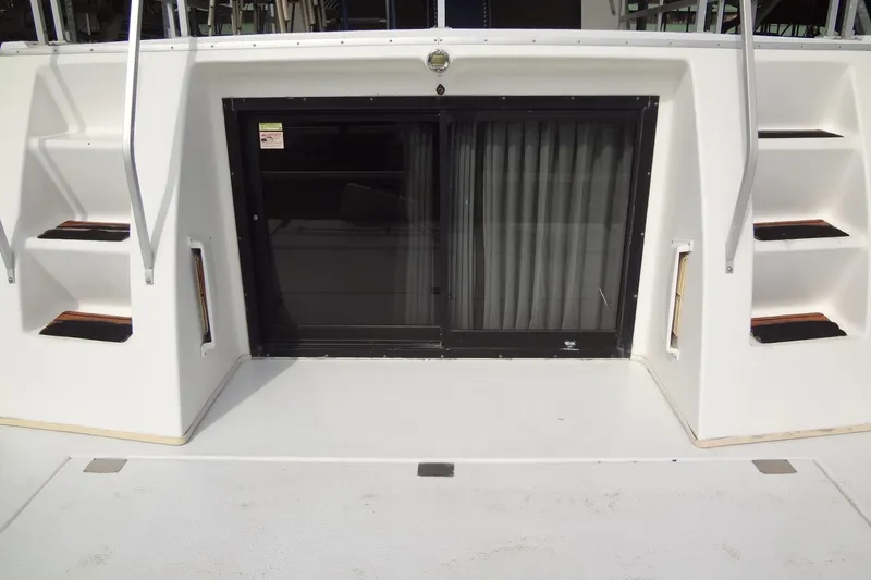 Slide: The Image of Gibson 44 boat, 2005 model, featuring rear deck with sliding glass door and steps. - 14