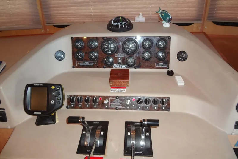 Slide: The Image of Control panel of a 2005 Gibson 44 boat with gauges and navigation equipment. - 22