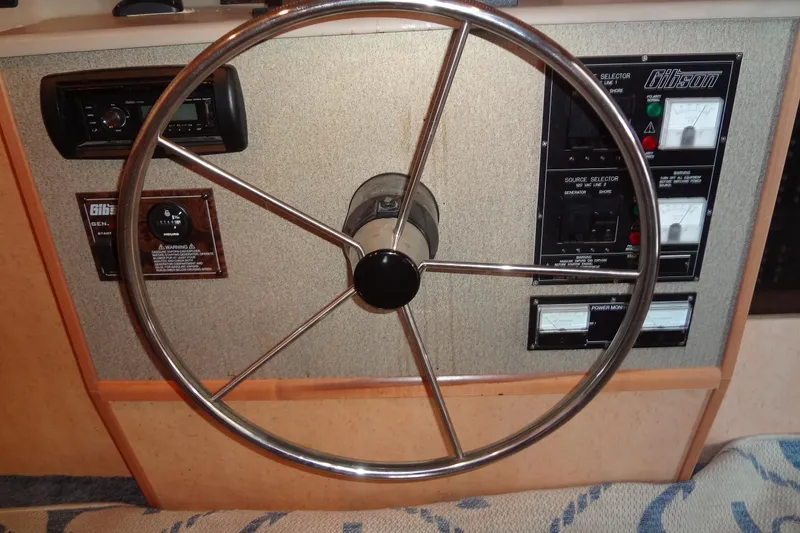 Slide: The Image of Steering wheel and control panel of a 2005 Gibson 44 boat. - 23