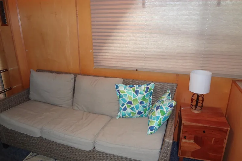 Slide: The Image of Cozy living area with wicker sofa, colorful pillows, and wooden side table in a 2005 Gibson 44. - 26