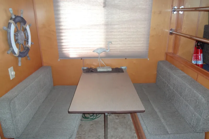 Slide: The Image of Cozy dining area in a 2005 Gibson 44 boat with nautical decor. - 30