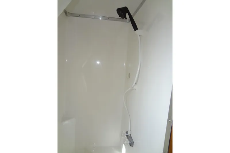 Slide: The Image of Shower area in a 2005 Gibson 44 boat, featuring a handheld showerhead. - 41