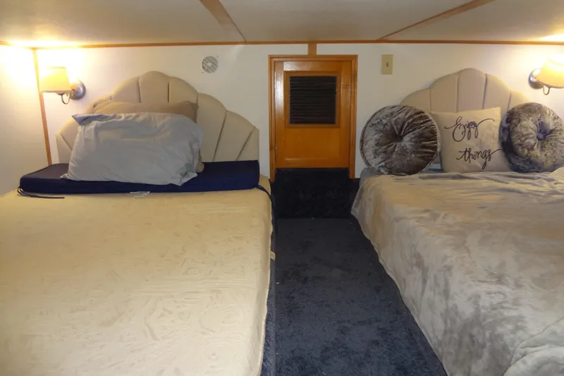 Slide: The Image of Cozy bedroom in 2005 Gibson 44 boat with twin beds and decorative pillows. - 44