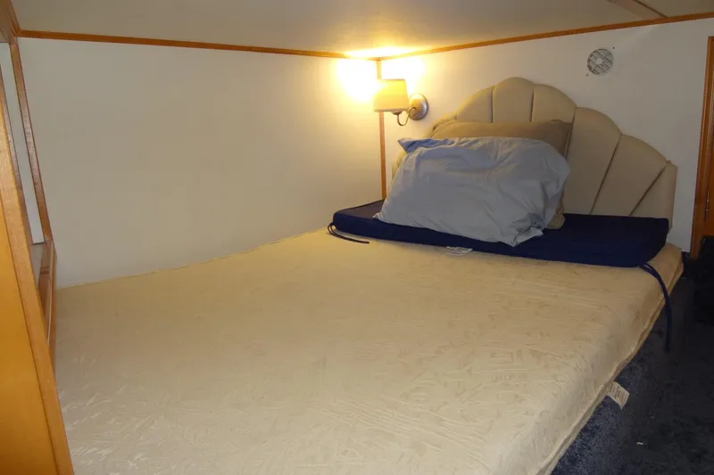 Slide: The Image of Cozy bedroom in 2005 Gibson 44 boat with soft lighting and plush bedding. - 45
