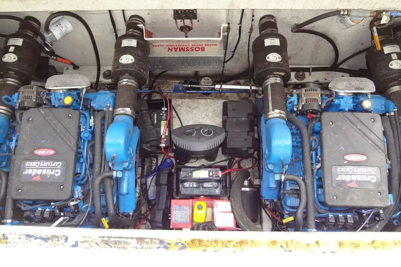 Slide: The Image of Engine compartment of a 2005 Gibson 44 boat with Crusader engines and marine components. - 49