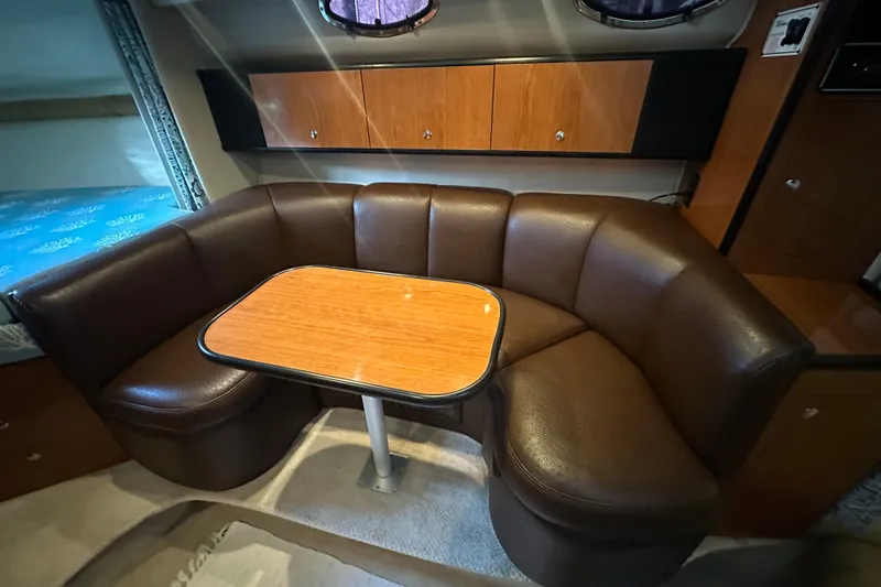 Slide: The Image of 2000 Chaparral Signature 300 interior with brown leather seating and wooden table. - 19