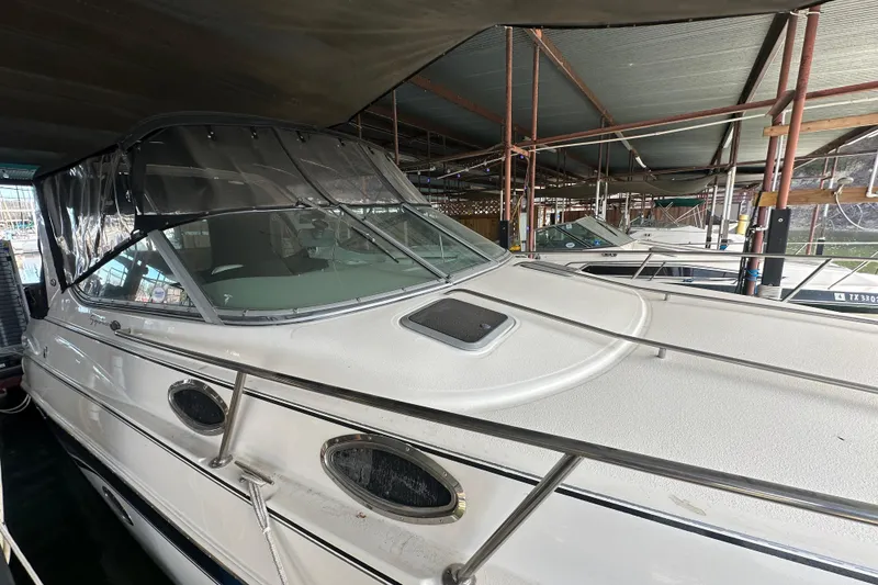 Slide: The Image of 2000 Chaparral Signature 300 boat docked under a covered marina. - 2