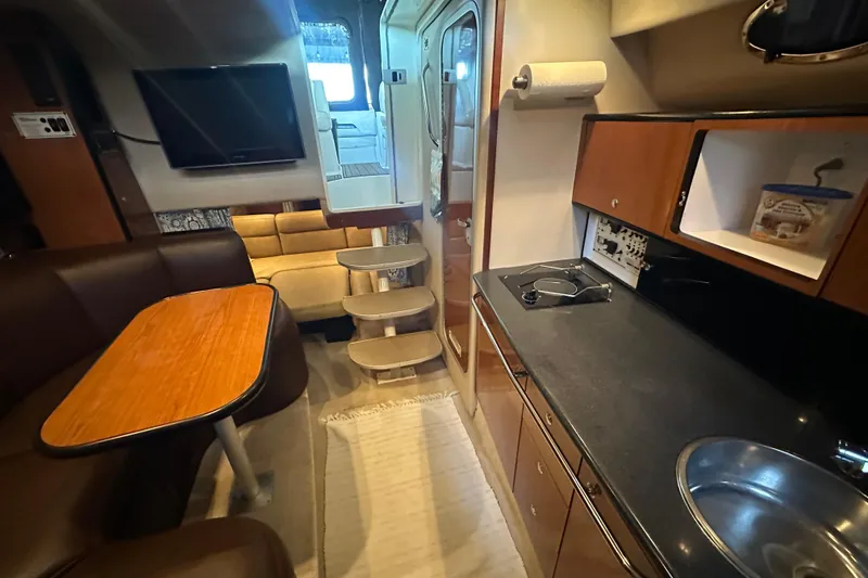 Slide: The Image of Interior of 2000 Chaparral Signature 300 boat with kitchen, seating, and stairs. - 24