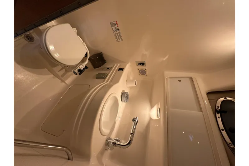 Slide: The Image of 2000 Chaparral Signature 300 boat bathroom with toilet, sink, and storage. - 27