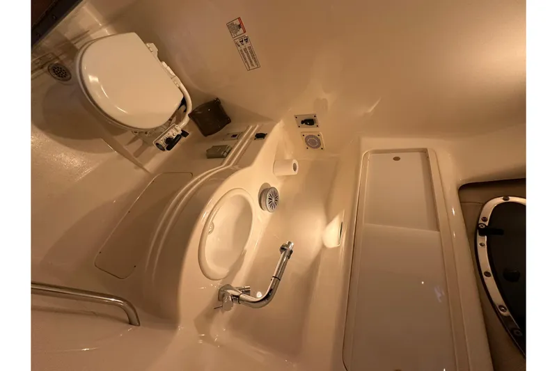 Slide: The Image of 2000 Chaparral Signature 300 boat bathroom interior with sink and toilet. - 28