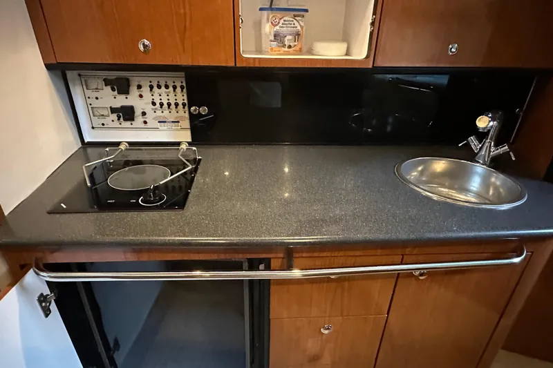 Slide: The Image of Compact kitchen area in 2000 Chaparral Signature 300 boat with stove and sink. - 29