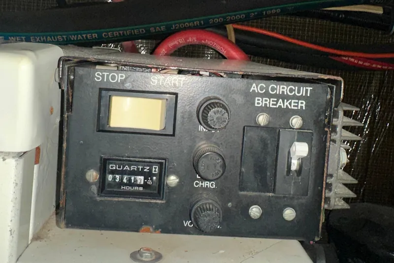 Slide: The Image of Control panel of a 2000 Chaparral Signature 300 boat with AC circuit breaker. - 38