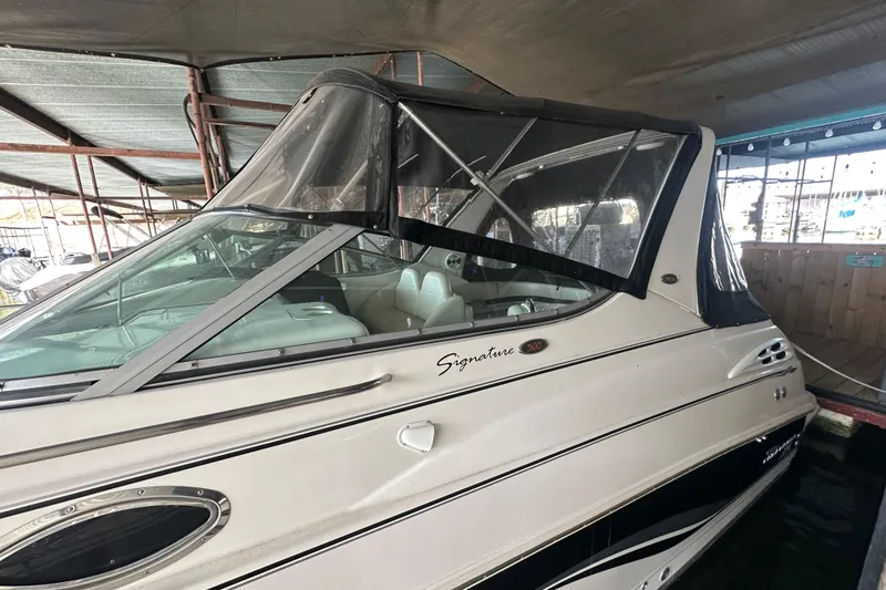 Slide: The Image of 2000 Chaparral Signature 300 boat with covered cockpit, docked in a marina. - 8