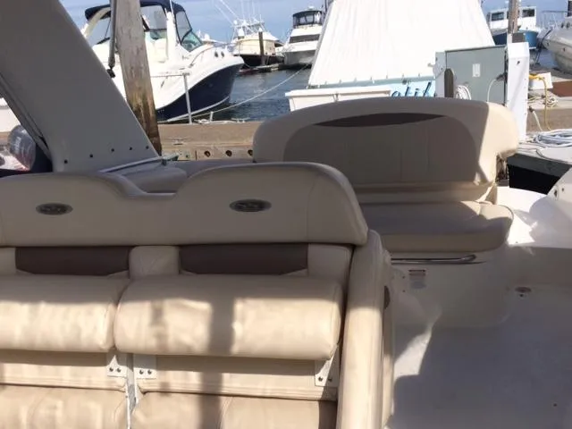 Slide: The Image of 2007 Chaparral 275 SSi boat interior with beige seating at a marina. - 3
