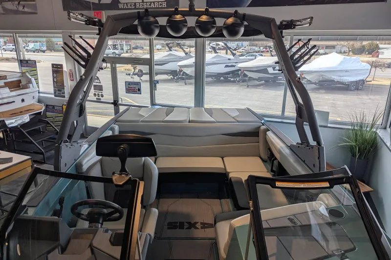 Slide: The Image of 2026 Axis A200 boat interior with seating and steering wheel in showroom. - 14