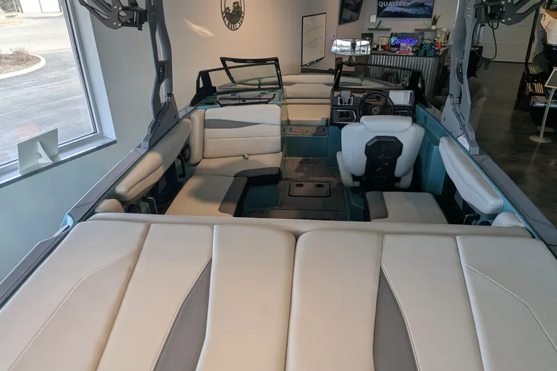 Slide: The Image of 2026 Axis A200 boat interior with modern seating and dashboard in showroom. - 3