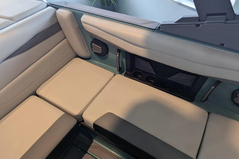 Slide: The Image of Interior seating of 2026 Axis A200 boat, featuring beige and black upholstery. - 8