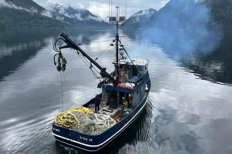 The Image of Custom 54 Steel Fishing Vessel, 1976, navigating serene Alaskan waters with fishing gear. - 0