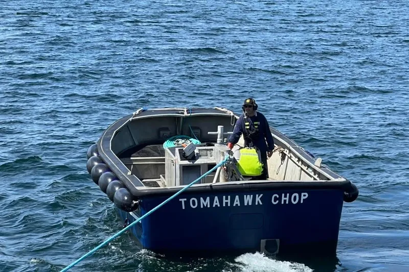 Slide: The Image of 1976 Custom 54 Steel Fishing Vessel 'Tomahawk Chop' on open water, crew member aboard. - 4
