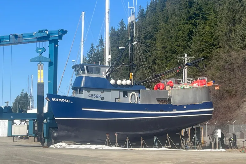 Slide: The Image of 1976 Custom 54 Steel Fishing Vessel on land, surrounded by trees and equipment. - 9