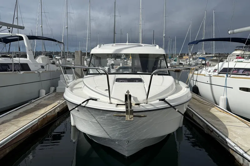 Slide: The Image of 2021 Beneteau Antares 8 docked at marina, surrounded by sailboats. - 3