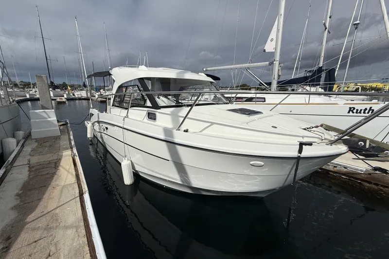 Slide: The Image of 2021 Beneteau Antares 8 docked at marina under cloudy sky. - 4