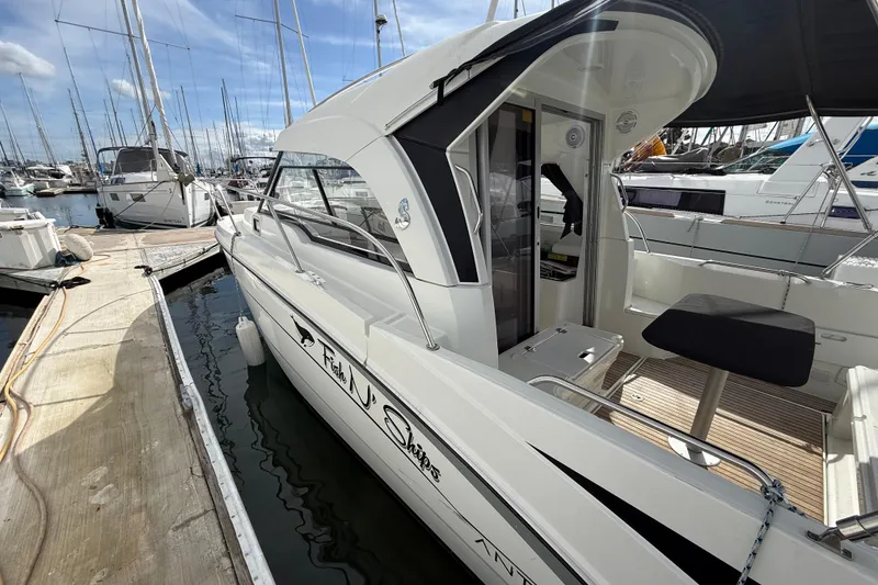 Slide: The Image of 2021 Beneteau Antares 8 docked at marina, showcasing sleek design and spacious deck. - 5