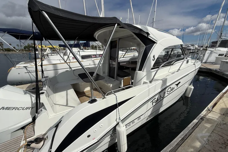 Slide: The Image of 2021 Beneteau Antares 8 boat docked at marina, featuring sleek design and canopy. - 8