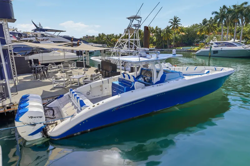 Slide: The Image of 2019 Midnight Express 43 Open boat docked, featuring sleek blue and white design. - 0