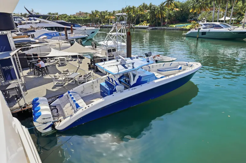 Slide: The Image of 2019 Midnight Express 43 Open boat docked at a marina with surrounding yachts. - 1