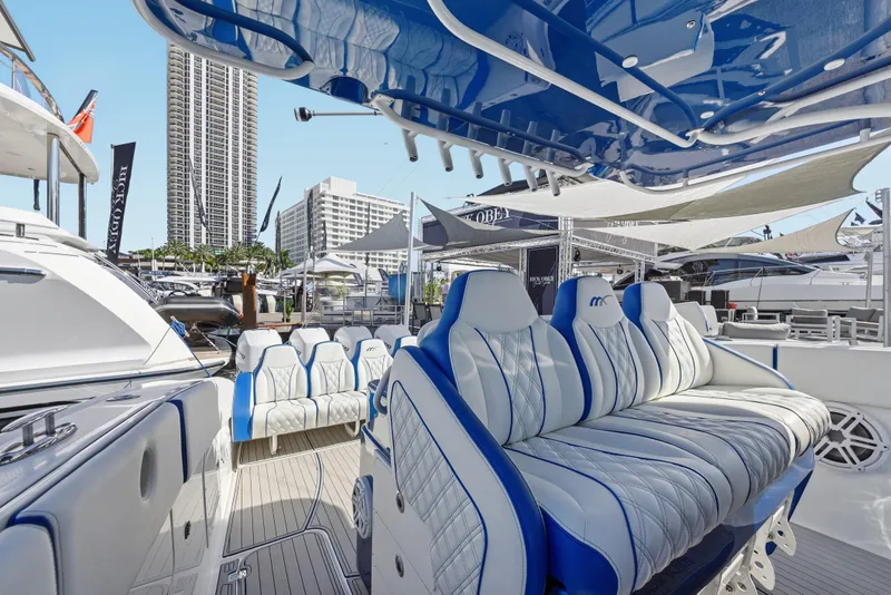 Slide: The Image of Luxurious 2019 Midnight Express 43 Open yacht interior with plush seating at a marina. - 11