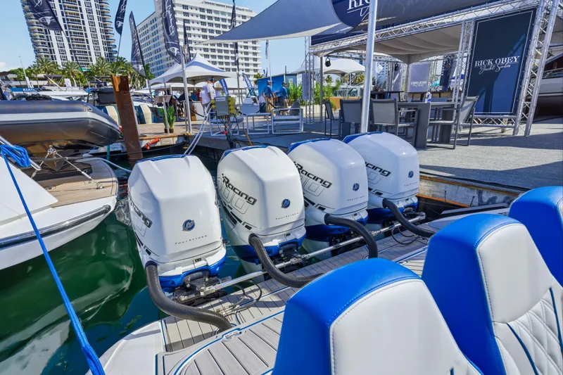 Slide: The Image of 2019 Midnight Express 43 Open boat with powerful outboard engines at a marina display. - 14