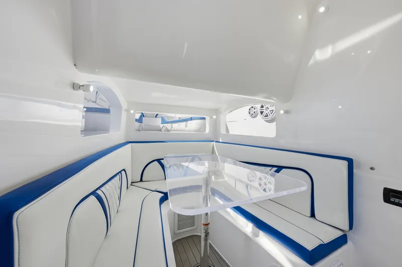 Slide: The Image of Luxurious interior of 2019 Midnight Express 43 Open boat with white and blue seating. - 18