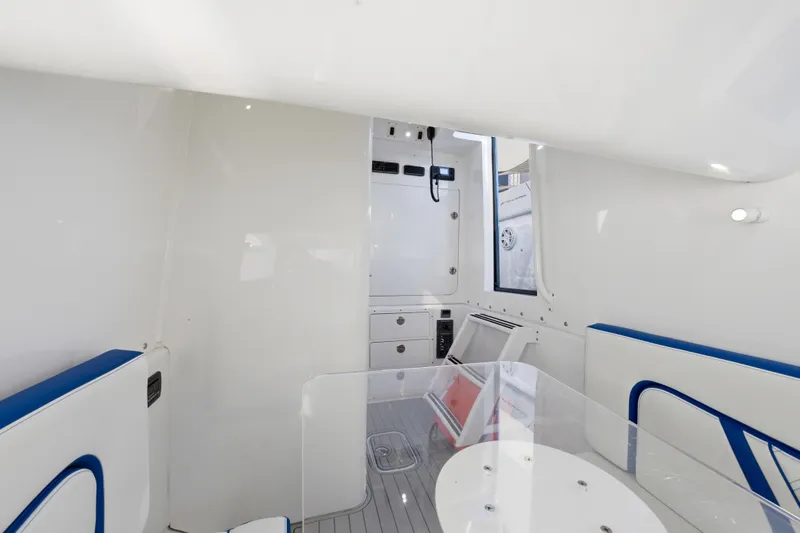 Slide: The Image of Interior of 2019 Midnight Express 43 Open boat, featuring sleek white and blue design. - 19