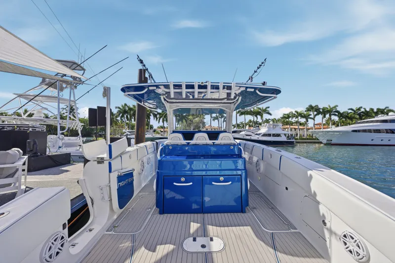 Slide: The Image of 2019 Midnight Express 43 Open boat docked, featuring sleek design and vibrant blue console. - 6
