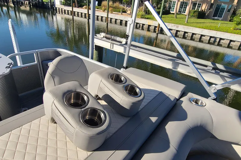Slide: The Image of 2023 Bennington L23 boat interior with cup holders and luxurious seating. - 10