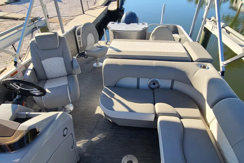 Slide: The Image of 2023 Bennington L23 pontoon boat interior with luxurious seating and modern design. - 13