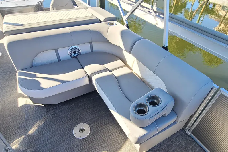 Slide: The Image of 2023 Bennington L23 boat interior with plush seating and cup holders. - 14