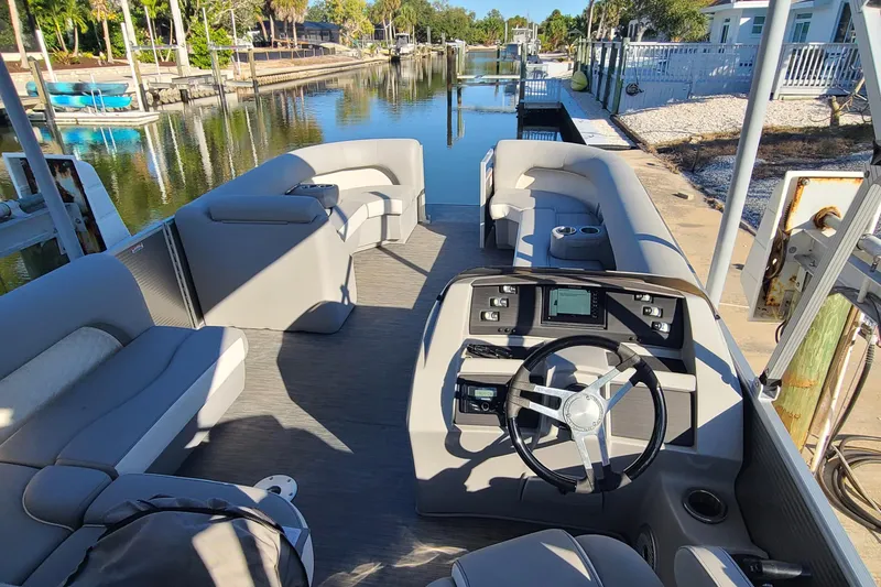 Slide: The Image of 2023 Bennington L23 pontoon boat interior with modern helm and spacious seating. - 5