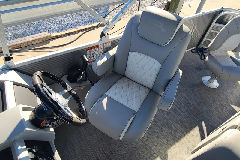 Slide: The Image of 2023 Bennington L23 boat interior with luxurious captain's chair and steering wheel. - 9