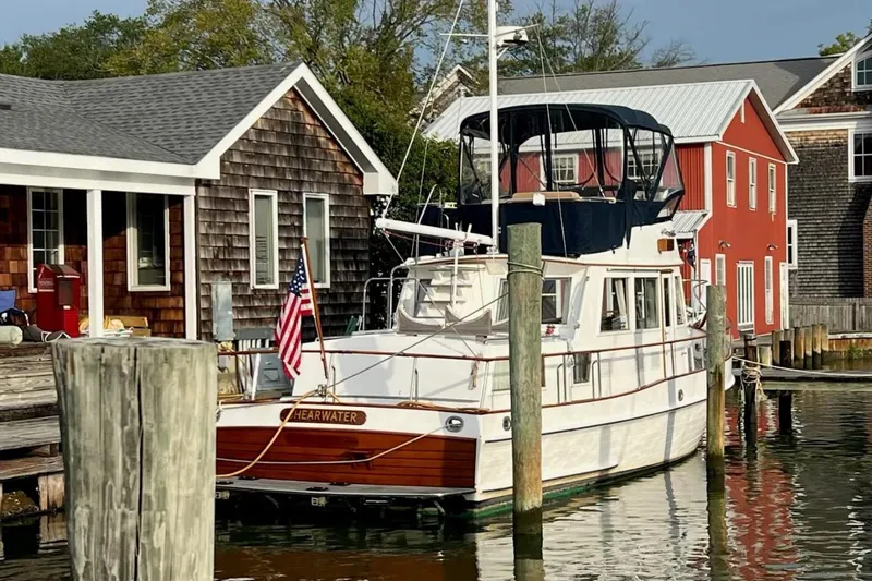 The Image of Grand Banks 36 Classic yacht docked near rustic waterfront buildings, 2000 model. - 0